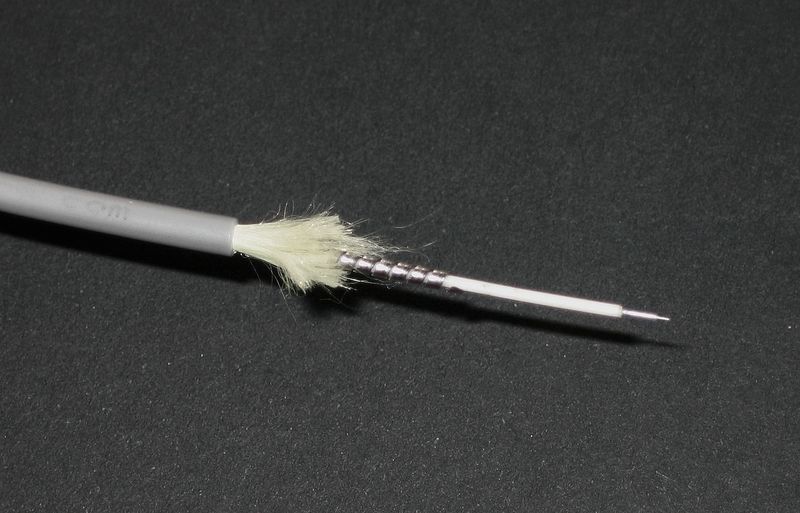 Bundled optical fibre strands lit from one end, a single path carrying many separate signals